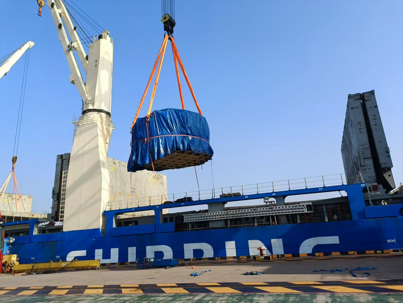 A large container being lifted by a crane

Description automatically generated